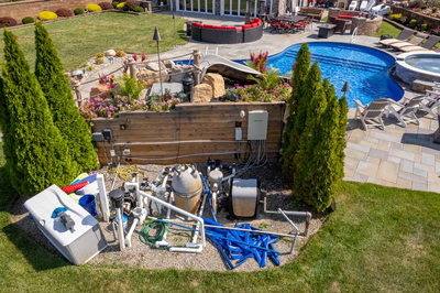 Chania L - Hamilton, NJ - A backyard with a swimming pool surrounded by landscaping and equipment