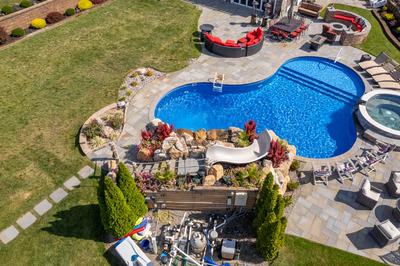 Chania M - Hamilton, NJ - A bird's eye view of a backyard with a swimming pool and landscaping
