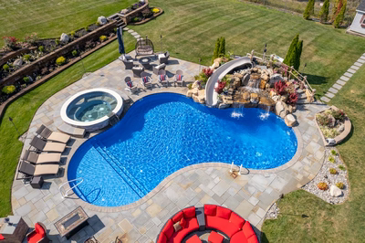 Chania O - Hamilton, NJ - A large backyard with a swimming pool and a waterfall feature