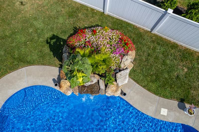 Chapel H - West Long Branch - A bird's eye view of a swimming pool surrounded by flowers and greenery