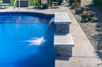 Chush E - Hamilton, NJ - A blue swimming pool with a water feature in the middle of it