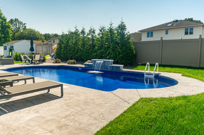 Chush G - Hamilton, NJ - A backyard with a swimming pool and a waterfall.
