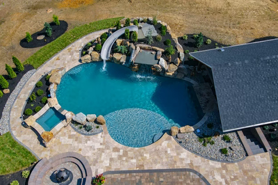Cispus U - Mantua, NJ - A bird's eye view of a backyard with a swimming pool and a waterfall