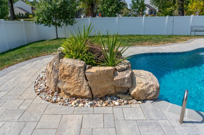 Cliff C - Bel Aire, MD - A backyard with a swimming pool and a rock feature in the center