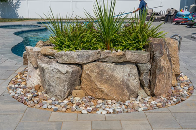 Cliff D - Bel Aire, MD - A man using a power washer to clean a pool surrounded by rocks and pebbles
