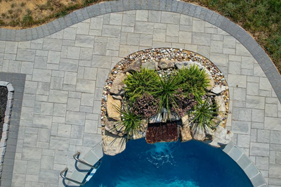 Cliff G - Bel Aire, MD - A bird's eye view of a swimming pool surrounded by a stone patio with a waterfall feature
