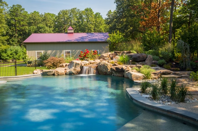 Coal B - Vincentown, NJ - A swimming pool with a waterfall in the middle surrounded by lush greenery