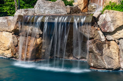 Copper E - Cream Ridge, NJ - A small waterfall cascades over rocks into a pool surrounded by greenery