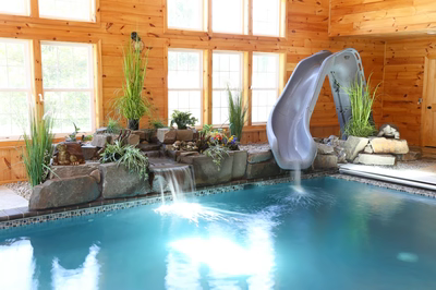 Cypress A - Bridgeton, NJ - A large indoor swimming pool with a water feature and a slide.