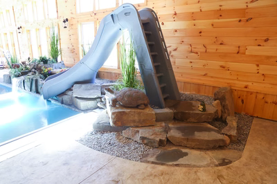 Cypress C - Bridgeton, NJ - A large indoor swimming pool with a water slide and a turtle statue