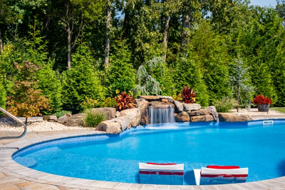 Datanla C - Brick, NJ - A swimming pool surrounded by lush greenery and a waterfall.