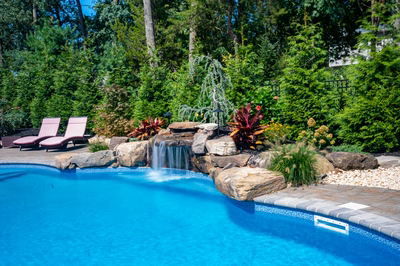 Datanla F - Brick, NJ - A swimming pool surrounded by lush greenery and a waterfall.
