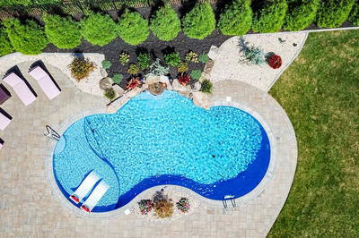 Datanla I - Brick, NJ - A bird's eye view of a swimming pool surrounded by lush greenery and landscaping