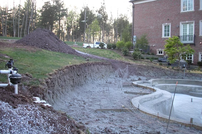 Dawa C - Bedminster, NJ - A large brick house with a large pile of dirt next to it.