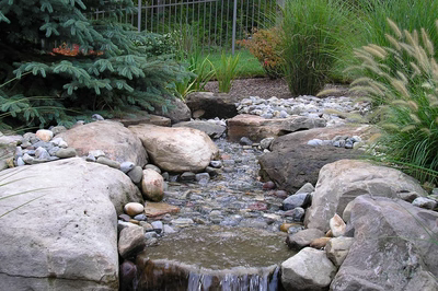 Dawa F - Bedminster, NJ - A small stream running through a garden filled with rocks and plants