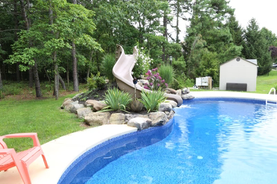 Dawson D - Jackson, NJ - A swimming pool with a water feature and a slide in a backyard setting
