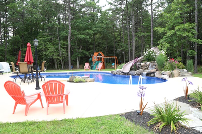 Dawson G - Jackson, NJ - A backyard with a swimming pool, a play area, and a water feature