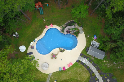 Dawson I - Jackson, NJ - A bird's eye view of a backyard with a swimming pool surrounded by trees