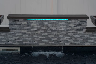 Dune C - Brigantine, NJ - A water feature with a blue light on top of a stone wall.