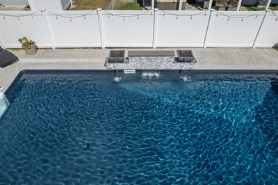 Dune O - Brigantine, NJ - A rectangular swimming pool with clear blue water and a waterfall feature