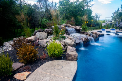 Elowah D - Collegeville, PA - A backyard with a swimming pool and a waterfall feature