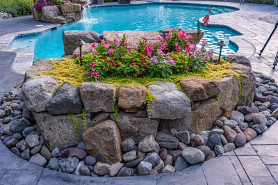 Franconia K - Malvern, PA - A rock garden around a swimming pool with flowers and a waterfall