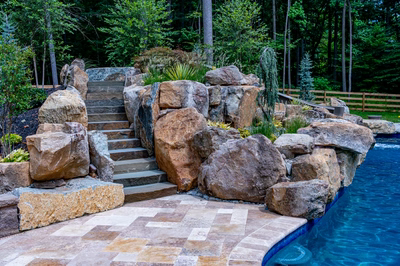 Gavarnie J - Monkton, MD - A large rock garden next to a swimming pool with steps leading up to it