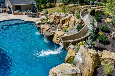 Gavarnie N - Monkton, MD - A swimming pool with a waterfall and a slide in a backyard setting