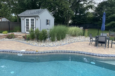 Georgiana A - Hillsborough, NJ - A backyard with a pool and a small shed.