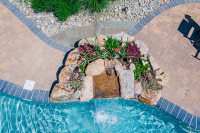 Georgiana E - Hillsborough, NJ - A bird's eye view of a swimming pool with a waterfall and landscaping