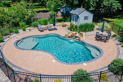 Georgiana I - Hillsborough, NJ - A backyard with a swimming pool surrounded by a black fence.