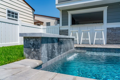 Gibbs E - Avalon, NJ - A backyard with a pool and a waterfall feature