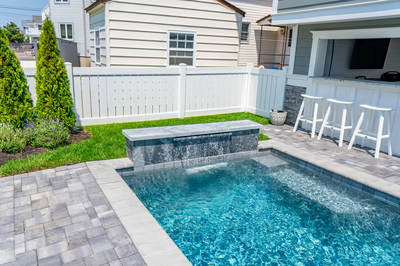 Gibbs F - Avalon, NJ - A small backyard with a pool and a bar area.