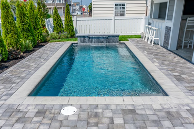 Gibbs G - Avalon, NJ - A small rectangular swimming pool surrounded by a white fence and paver patio.