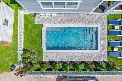 Gibbs I - Avalon, NJ - A bird's eye view of a house with a swimming pool surrounded by landscaping