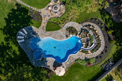 Gikira O - Bethlehem, PA - A bird's eye view of a backyard with a swimming pool surrounded by lush greenery