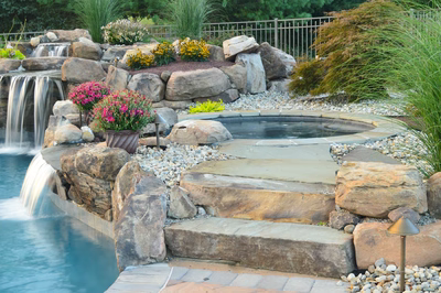 Ginga G - Ringoes, NJ - A beautiful backyard with a waterfall and a pool surrounded by rocks and plants