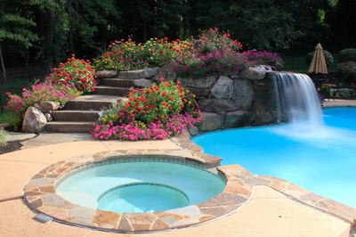 Gorge D - Huntington Valley, PA - A swimming pool with a waterfall and colorful flowers around it