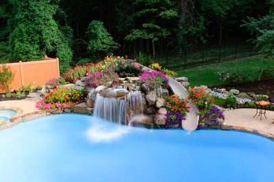 Gorge G - Huntington Valley, PA - A swimming pool with a waterfall and colorful flowers around it