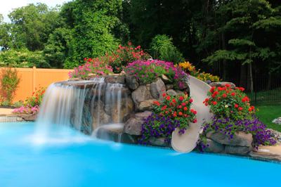 Gorge H - Huntington Valley, PA - A colorful garden with a waterfall and a water slide in the middle of a swimming pool