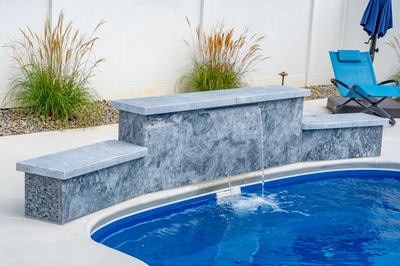 Haifoss B - Sicklerville, NJ - A pool with a waterfall feature and a lounge chair in a backyard setting