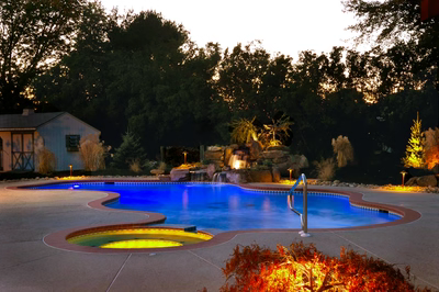 Harvard F - Sewell, NJ - A swimming pool lit up at night with a waterfall in the background