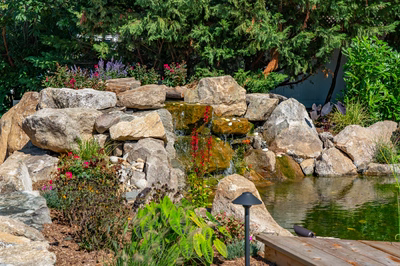 Havasu D - Manasquan, NJ - A rock garden with a small waterfall and colorful flowers