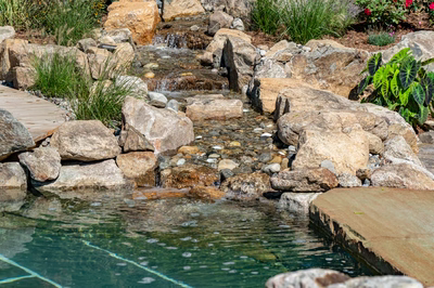 Havasu Q - Manasquan, NJ - A small pond with rocks and water features in a garden setting