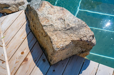 Havasu Z - Manasquan, NJ - A large rock sitting on top of a wooden deck next to a swimming pool