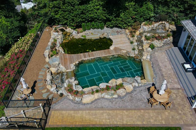 Havasu Z - Manasquan, NJ - A bird's eye view of a backyard with a swimming pool surrounded by lush greenery and flowers