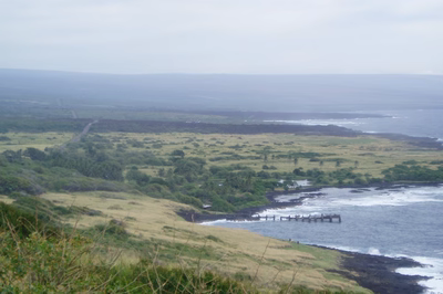 Hawaii5024B - A large rock waterfall in the middle of a swimming pool surrounded by lush greenery