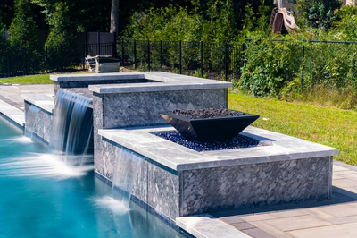 Haymeadow E - Mullica Hill, NJ - A modern outdoor water feature with a waterfall and a fire pit.
