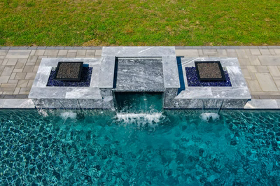Haymeadow I - Mullica Hill, NJ - A bird's eye view of a swimming pool with a water feature and fireplaces