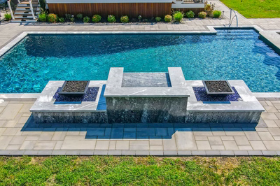 Haymeadow J - Mullica Hill, NJ - A rectangular swimming pool with a waterfall feature surrounded by stone pavers